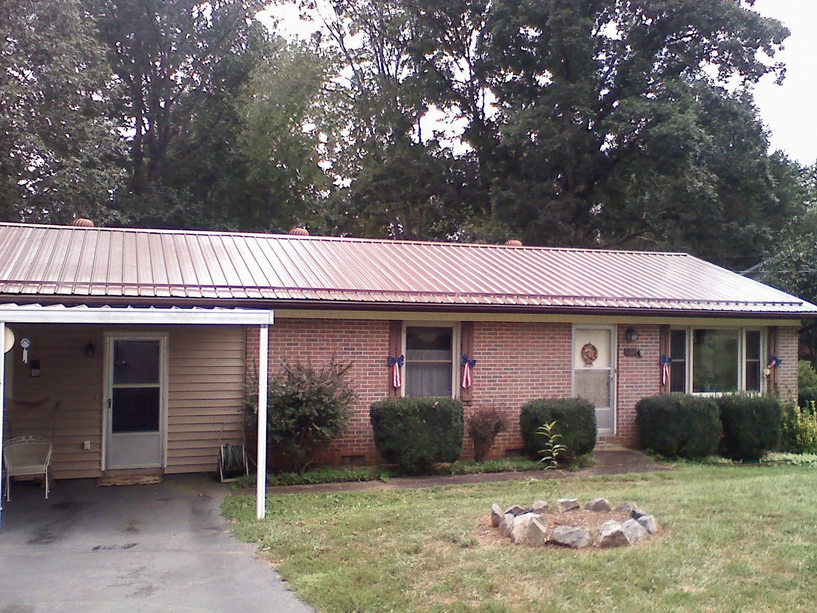 Bronze metal roof and carport on a brick ranch home — Roof Repair work by our crew in Grand Terrace